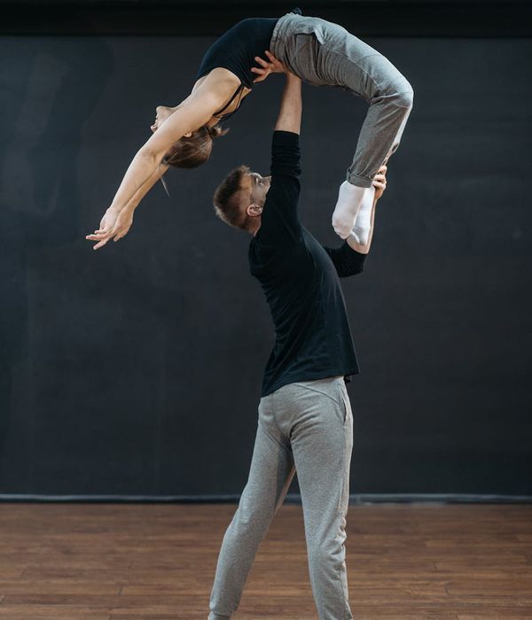 Man performing a controlled strength exercise in a bright studio.